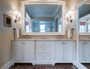 White bathroom interior with a large vanity mirror.