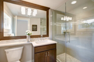 Hinged glass shower door in a bathroom.